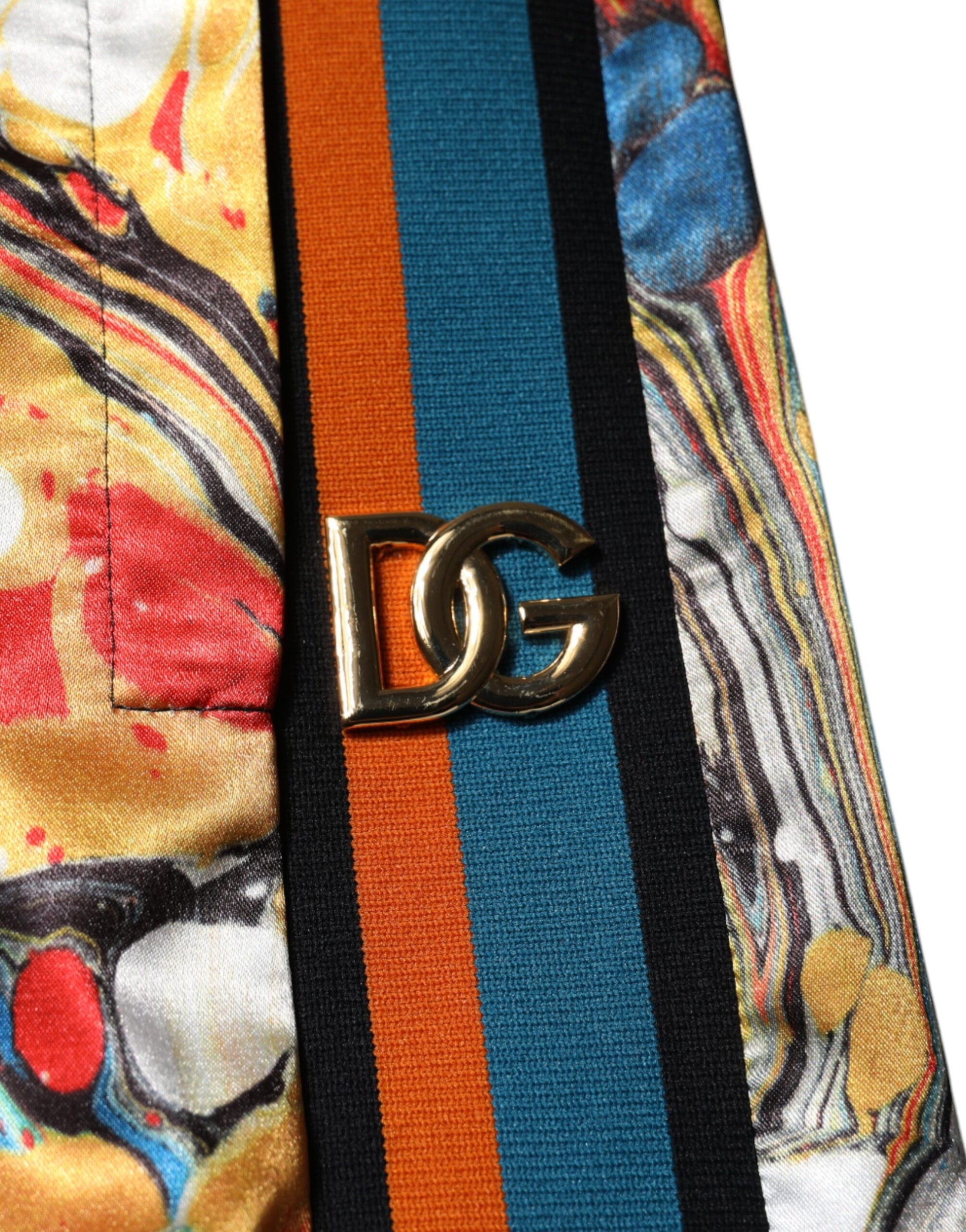 Colorful patterned fabric with a gold DG logo on the sleeve
