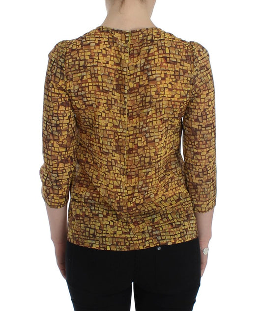 Back of a person wearing a yellow and brown patterned top