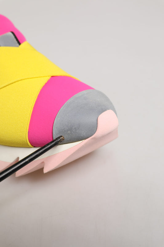 Pink and yellow sneaker with gray sole