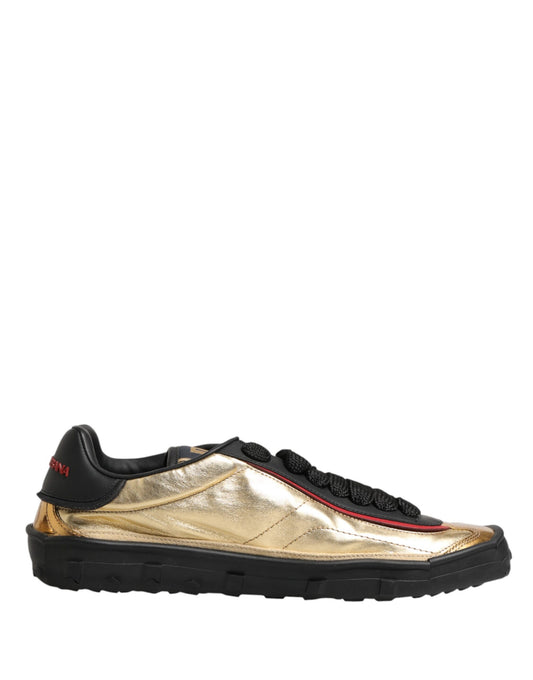 Gold lace-up sneakers with black sole and red accents