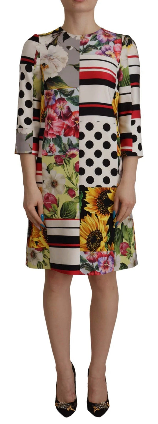 A woman wearing a multicolored floral shift dress with pachwork detailing