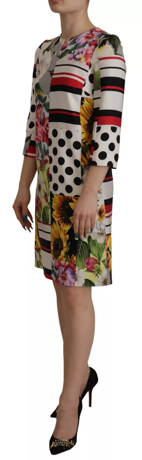 A woman wearing a colorful floral shift dress with paisley print