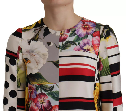 A colorful floral print dress with a striped pattern on the sleeves