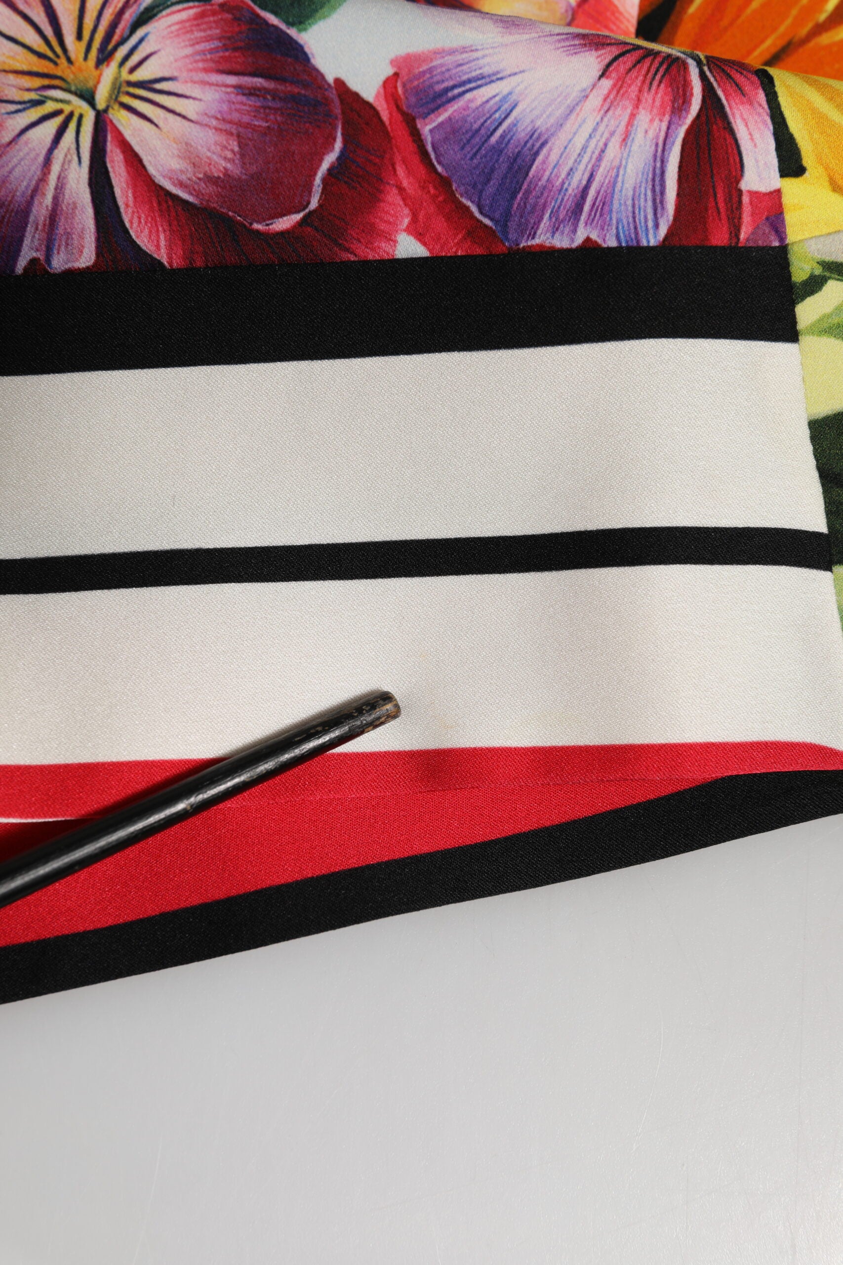 A multicolored pachwork charmeuse floral shift dress with red, white and black stripes