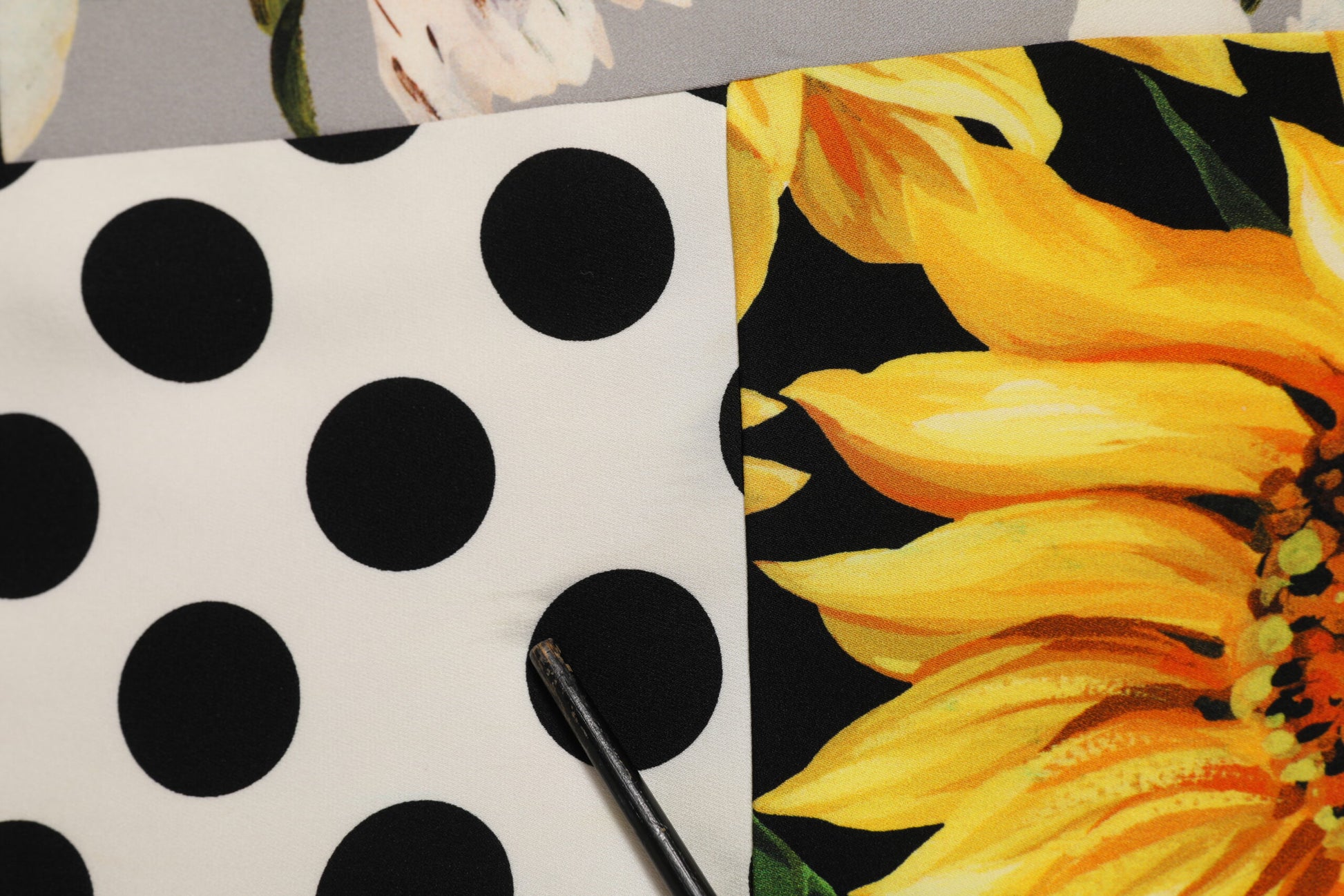 A multicolored floral shift dress with polka dots and a sunflower print