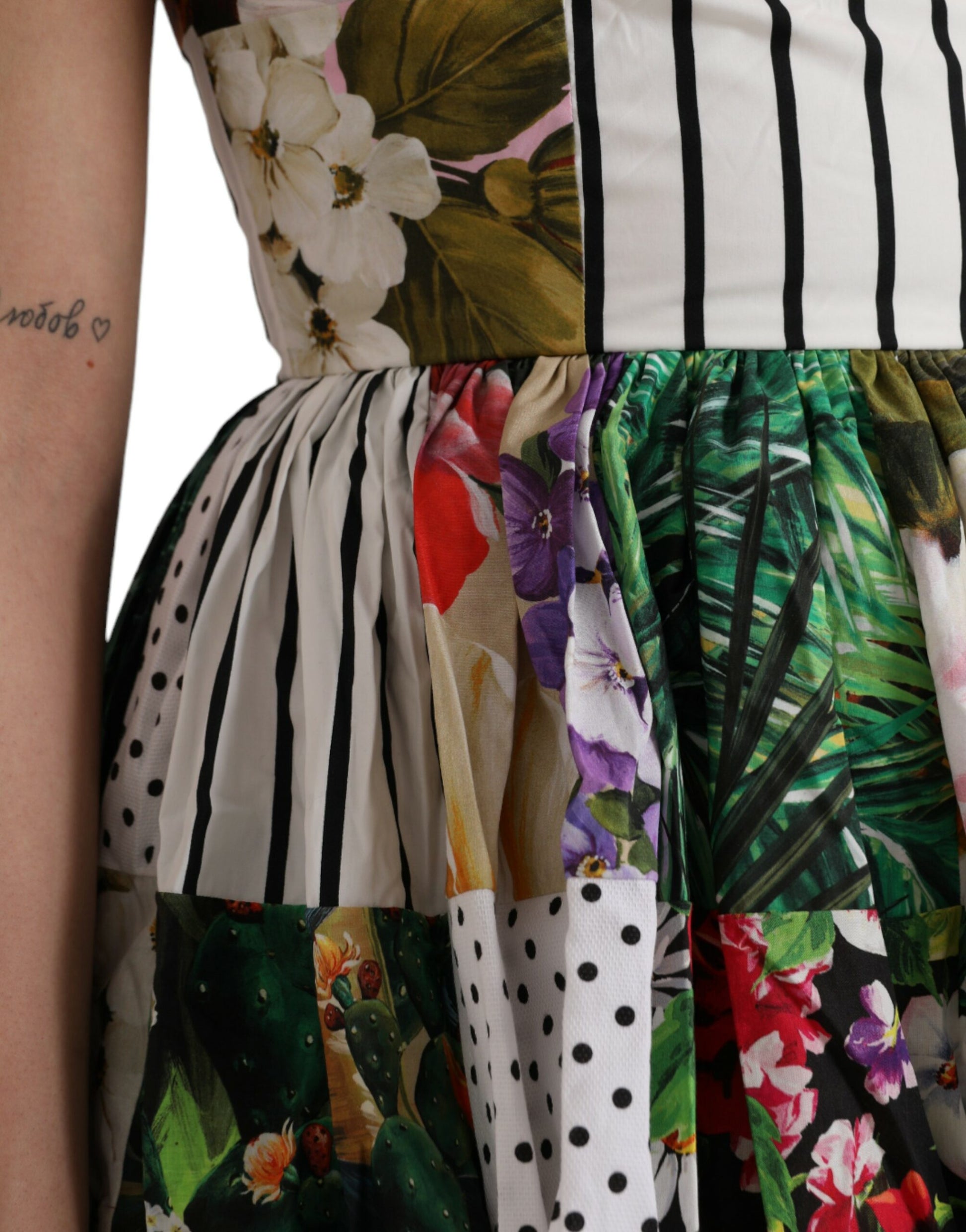 A colorful patchwork dress with floral patterns and polka dots, designed by Dolce & Gabbana