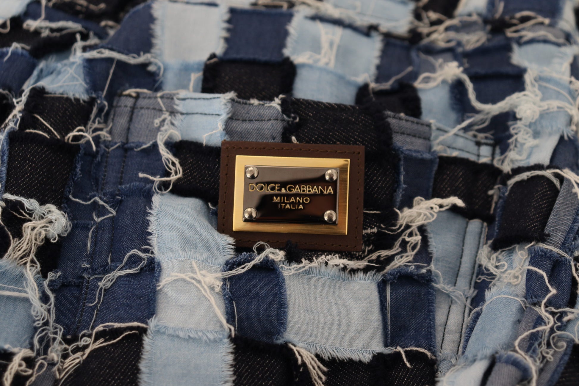 Blue denim jacket with gold logo on front