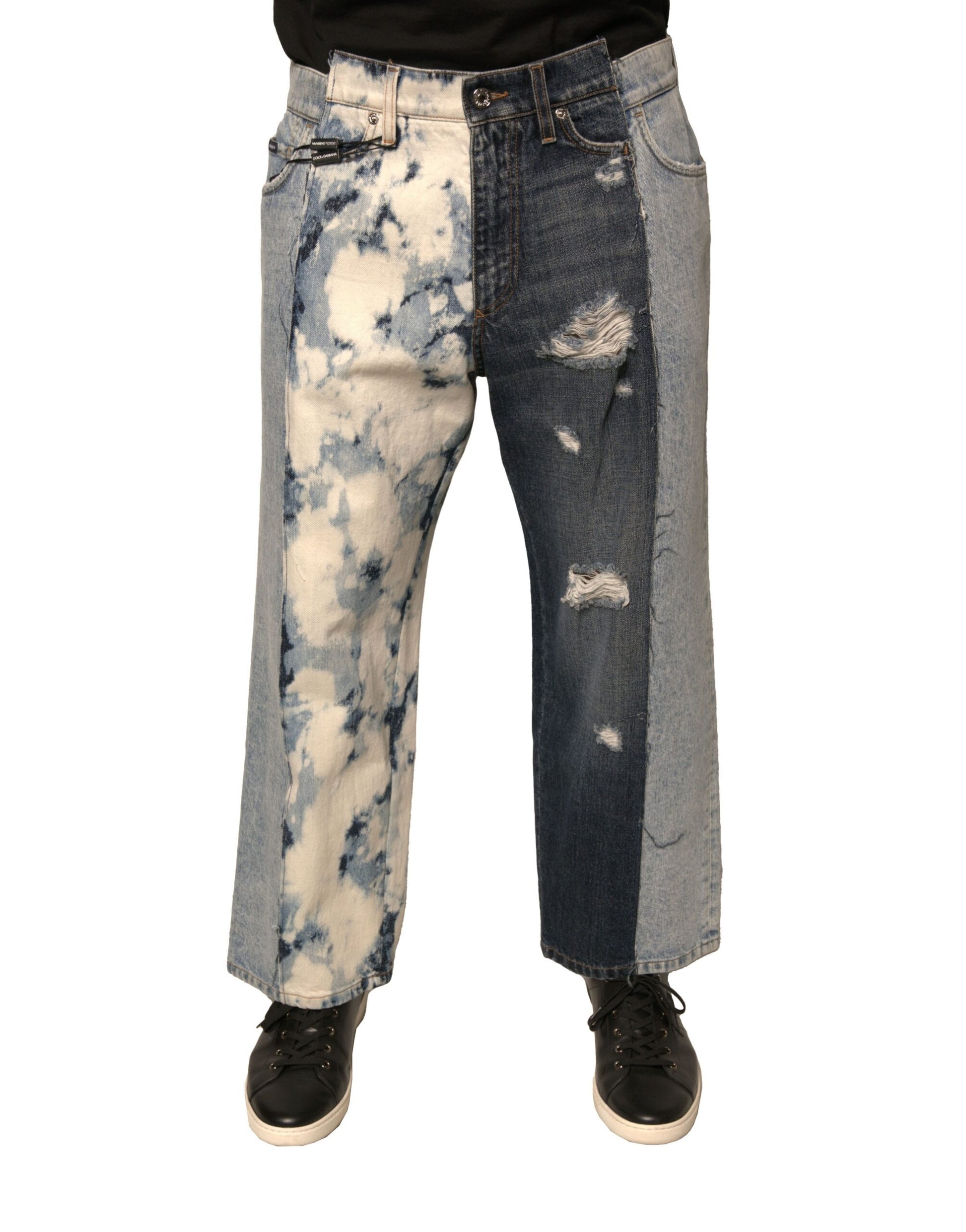 Pair of distressed jeans with patches of blue denim and white dye