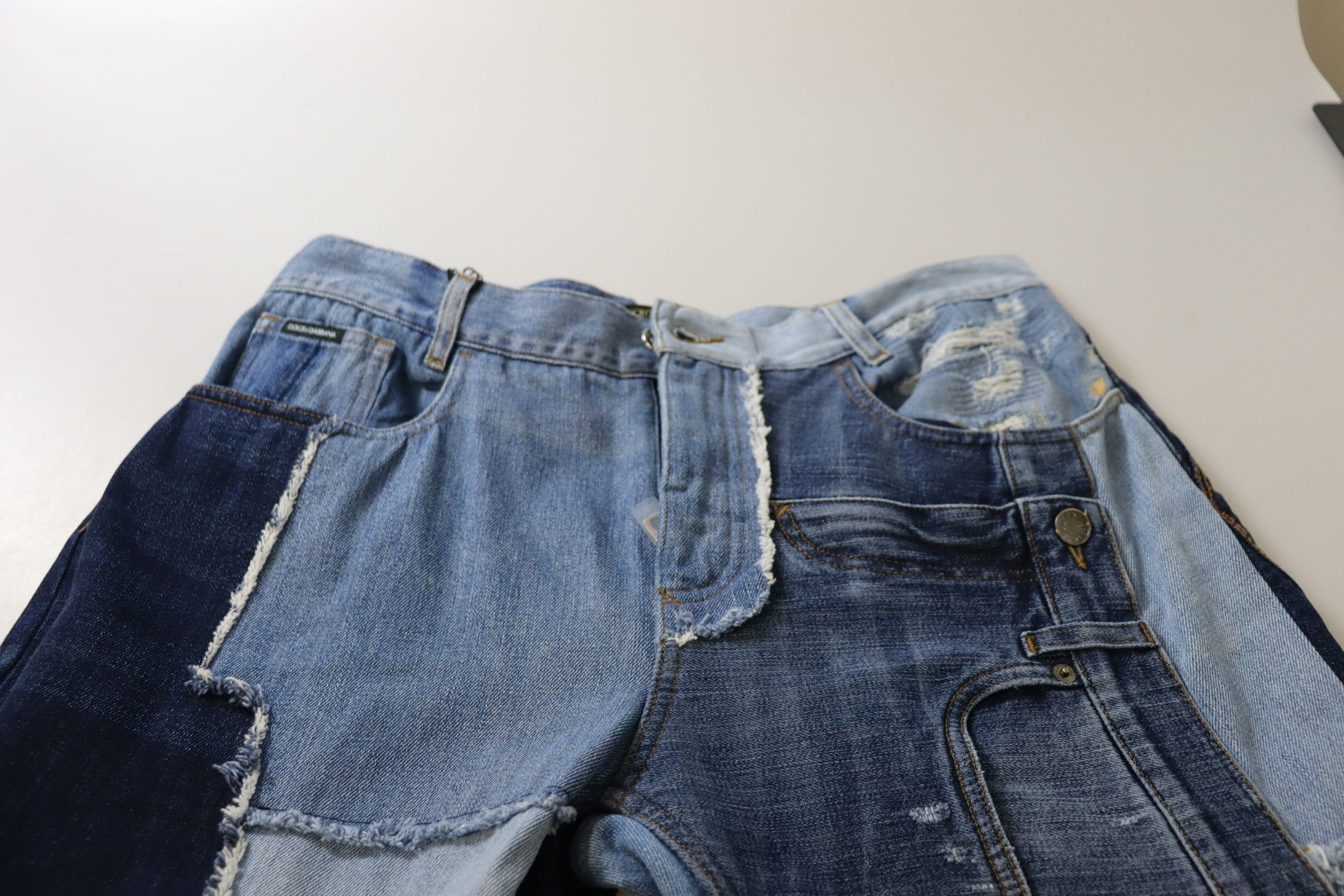 Pair of blue denim jeans with distressed areas