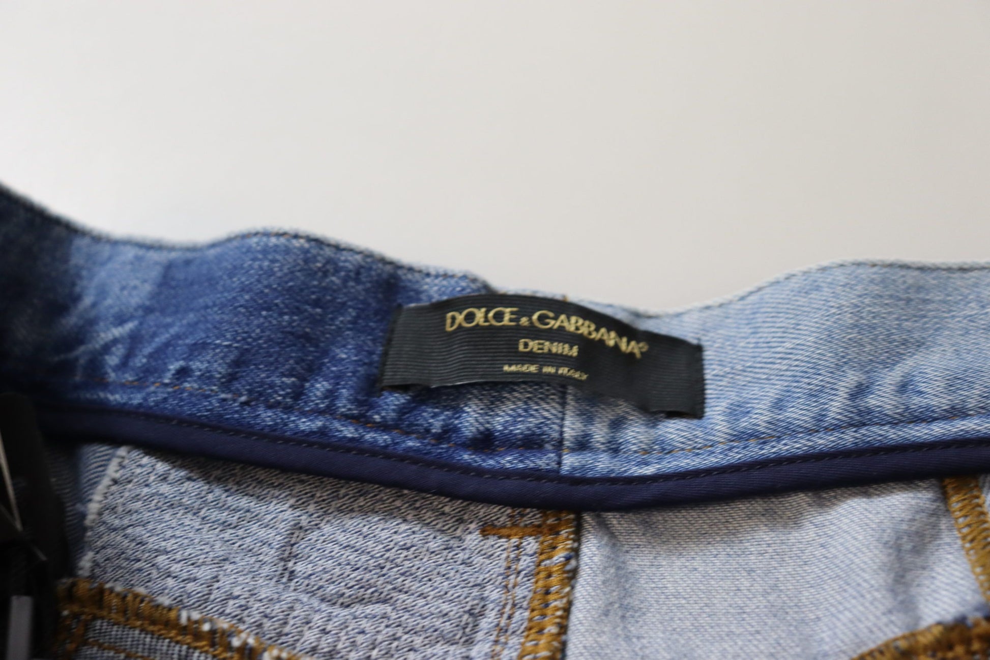 Blue denim jeans with a black label on waistband