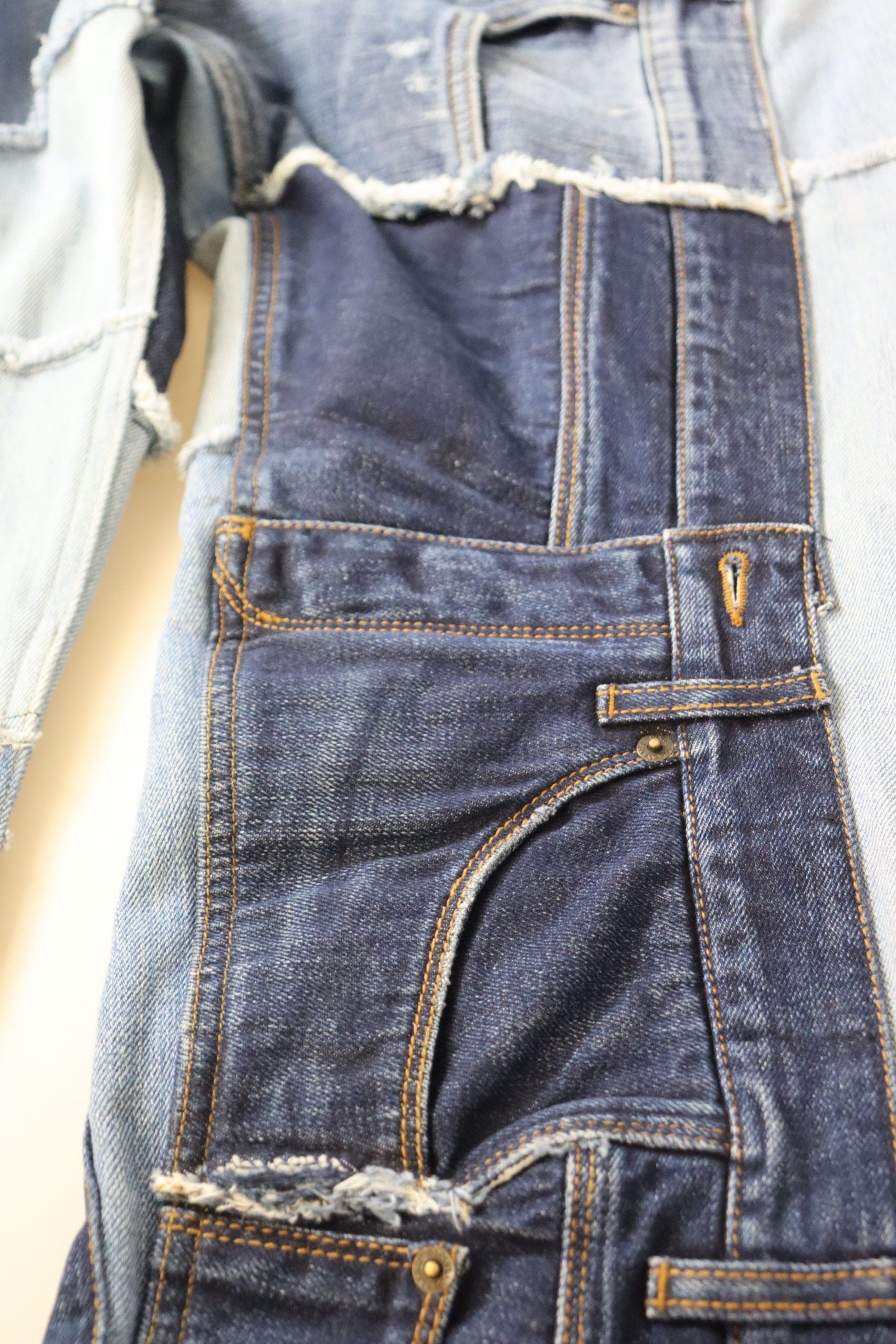 Blue denim jeans with faded areas and holes in knees