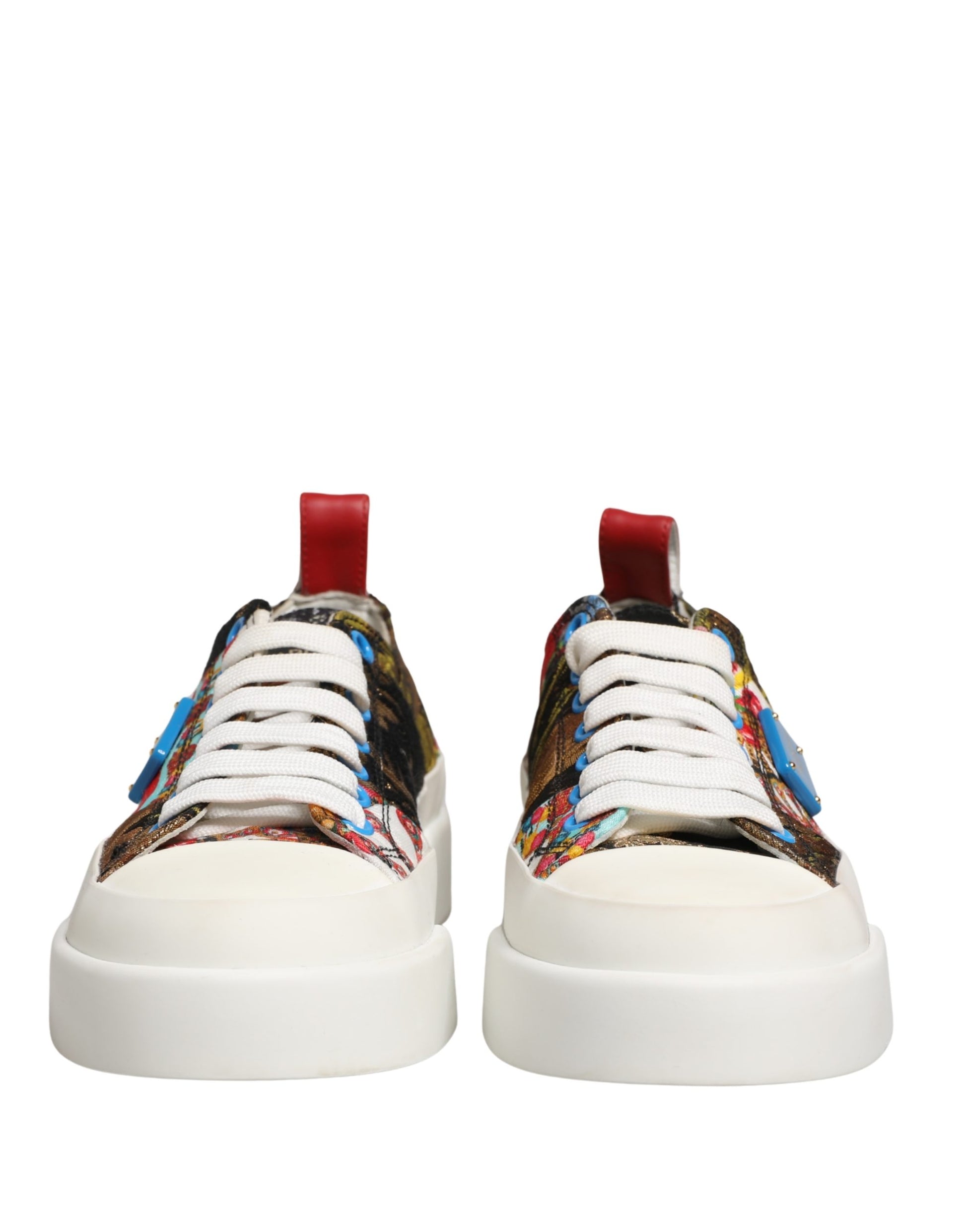 A pair of multicolored patchwork sneakers with a red lace and white sole