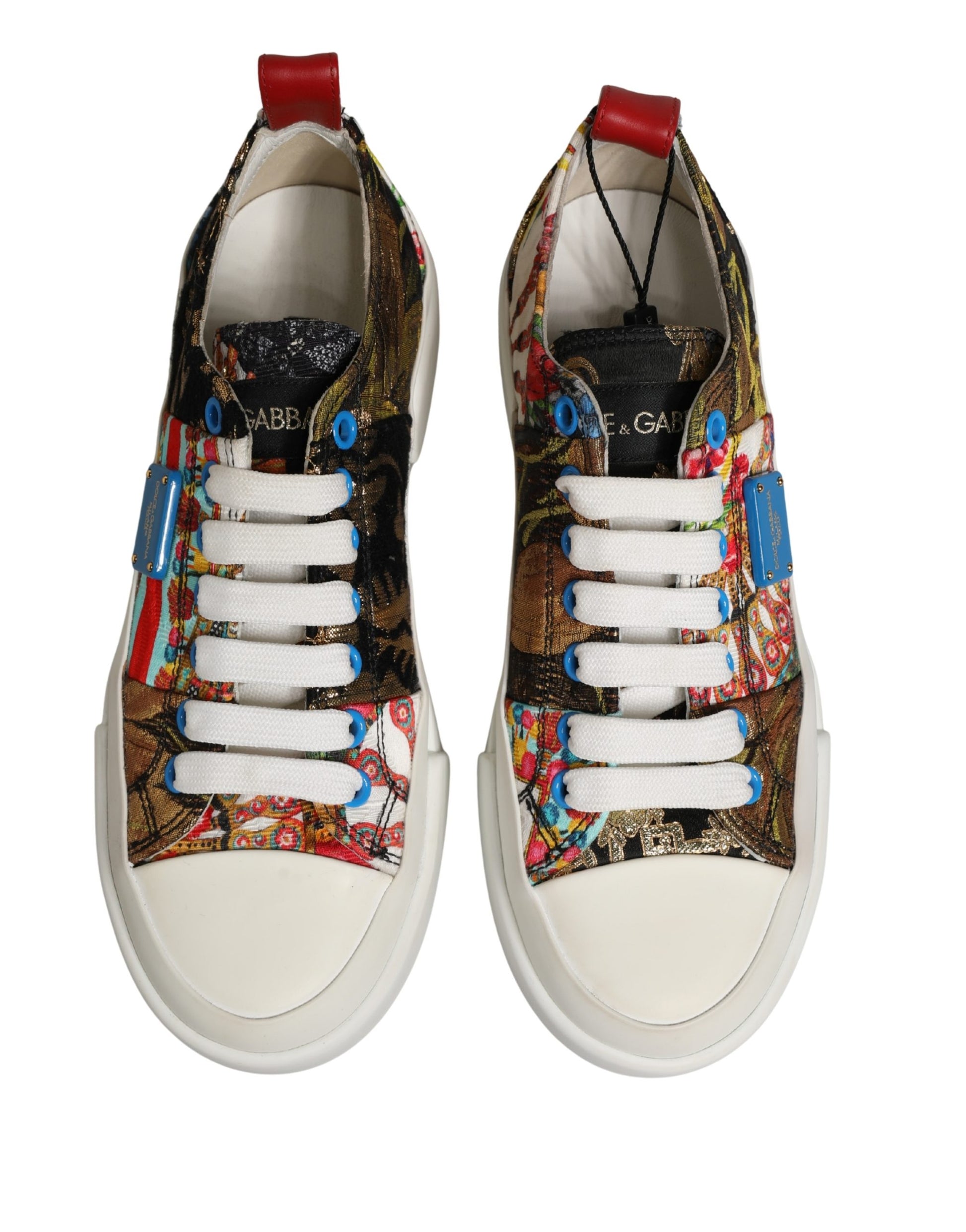 A pair of multicolored patchwork low top sneakers with white laces and a red heel
