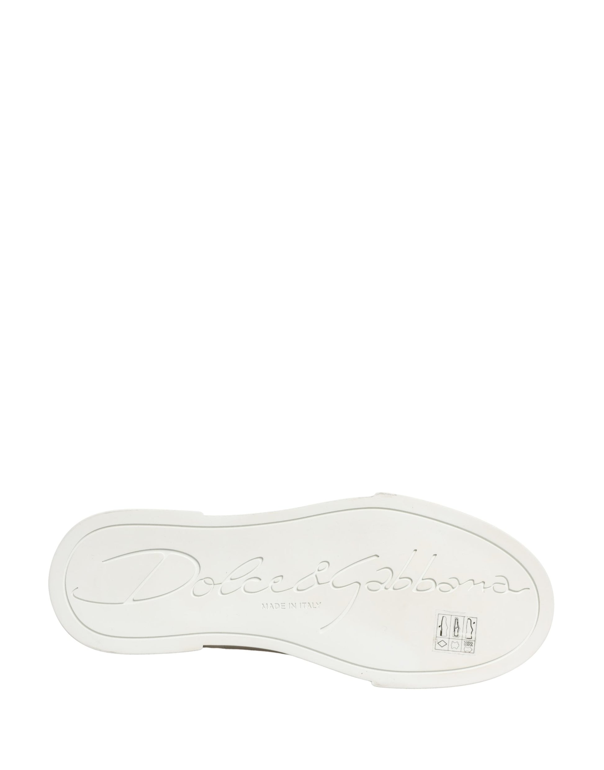 White sneaker with black text, patchwork design on side