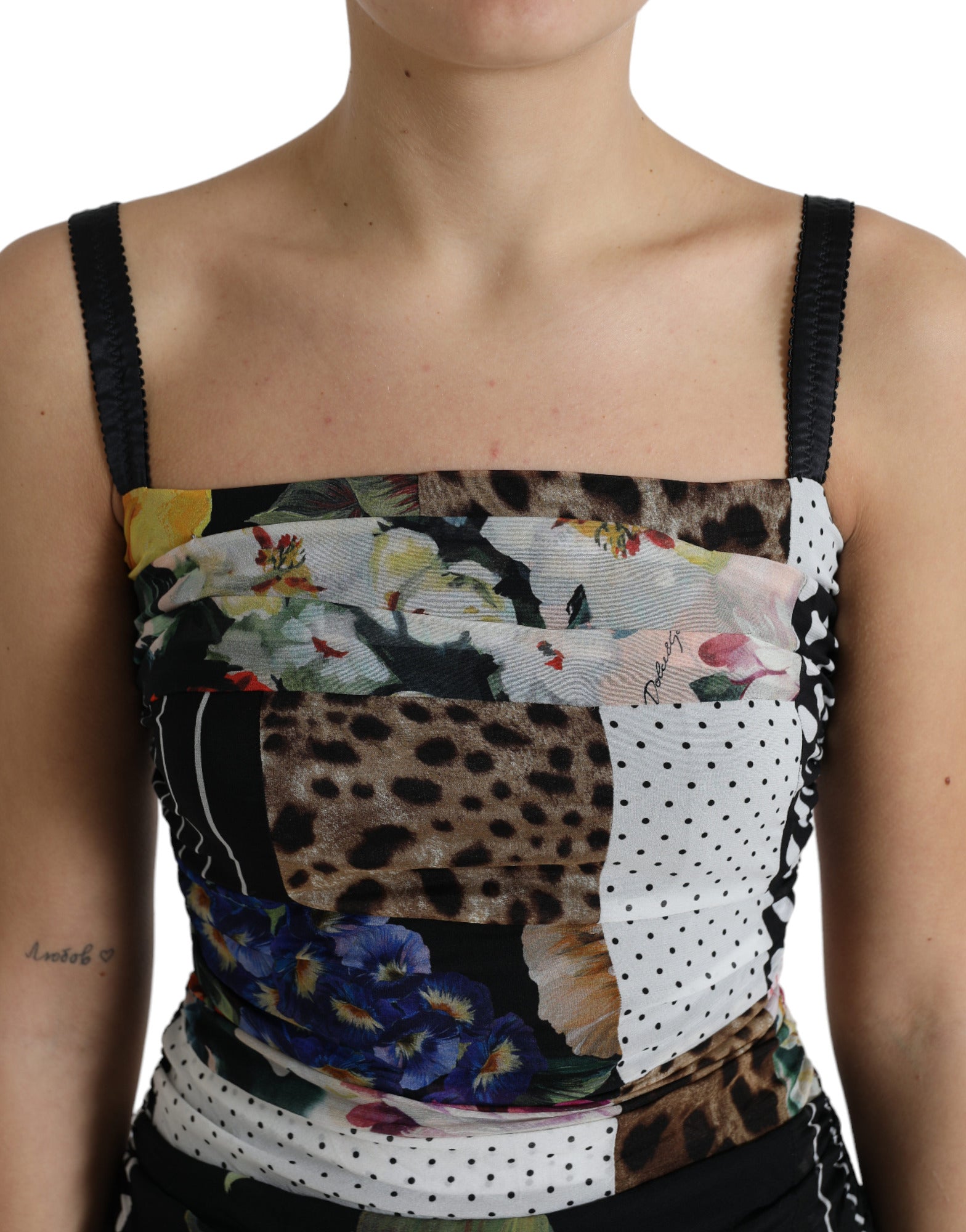 A woman wearing a multicolored patchwork midi dress with floral and leopard prints