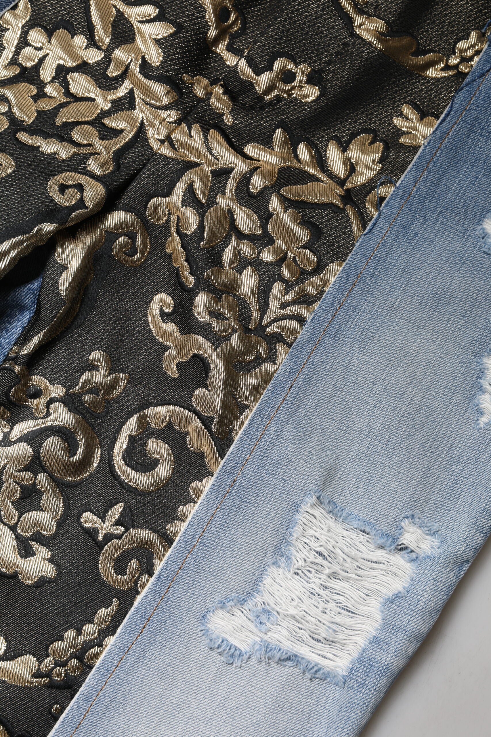 Gold embroidered fabric, black velvet, denim jeans with white patches