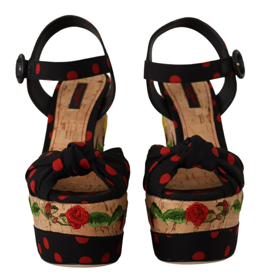 Pair of high heel shoes with red polka dots and floral designs on a wooden base