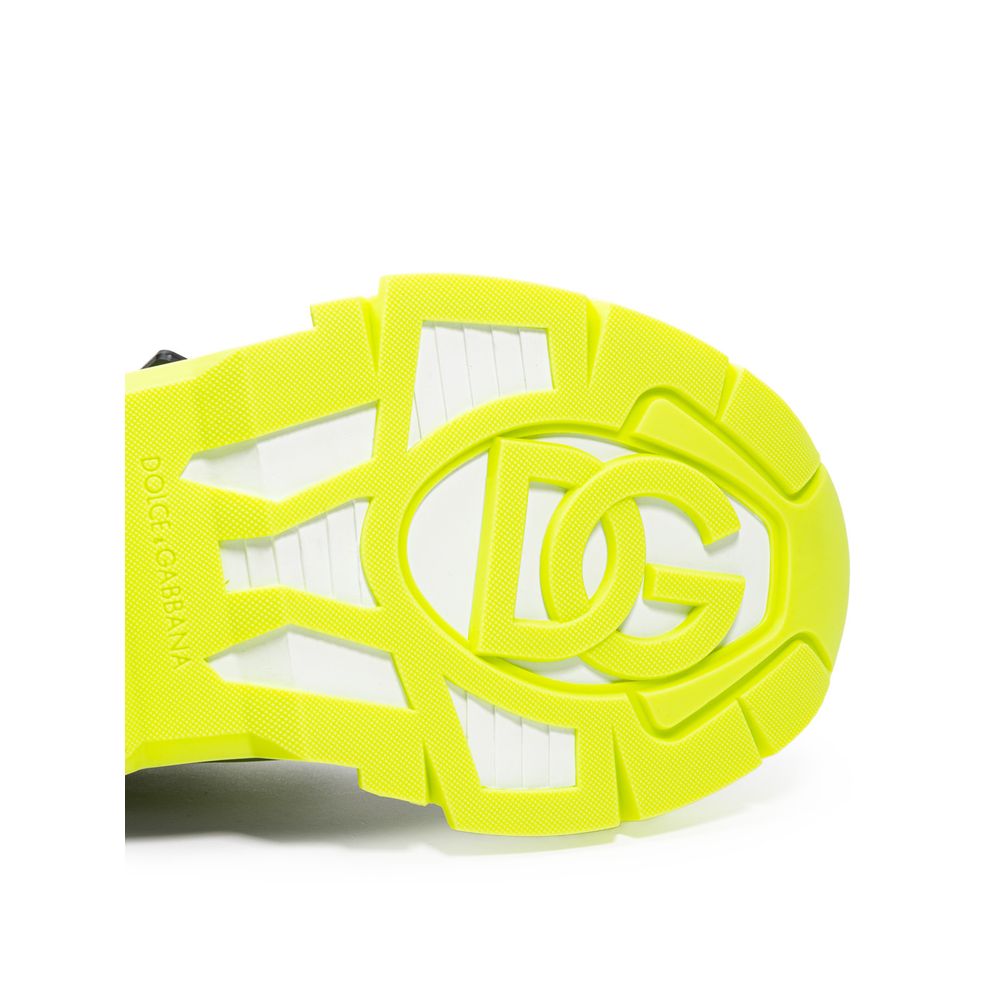 Yellow and white athletic shoe with black logo on side