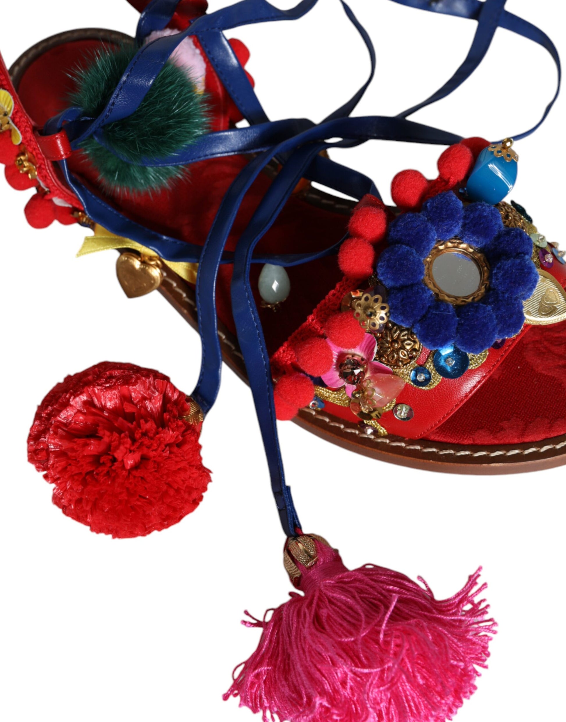 Decorative red shoe with embroidery, beads, tassels, and pom poms