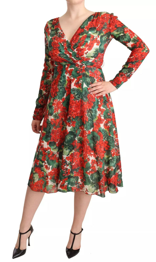 A woman wearing a red, white, and black floral print dress with a V-neckline