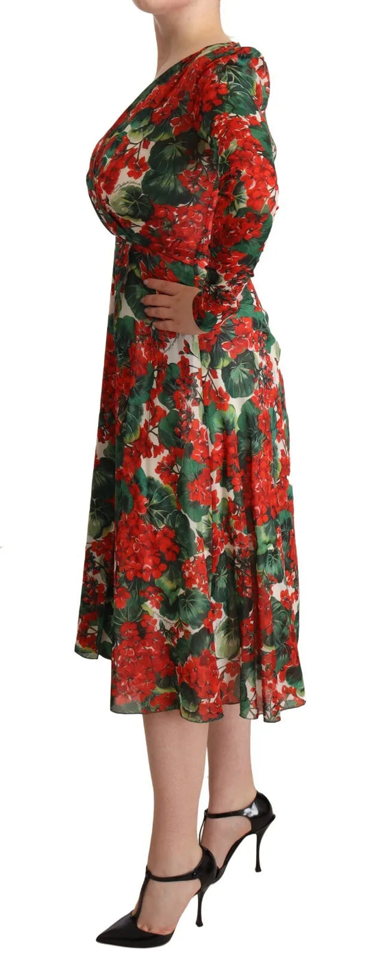 A woman wearing a red, white, and black floral print dress with long sleeves