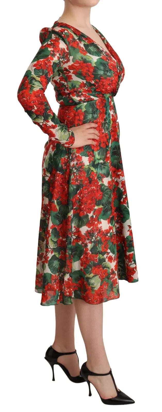 A woman wearing a floral print dress with long sleeves and a flared skirt