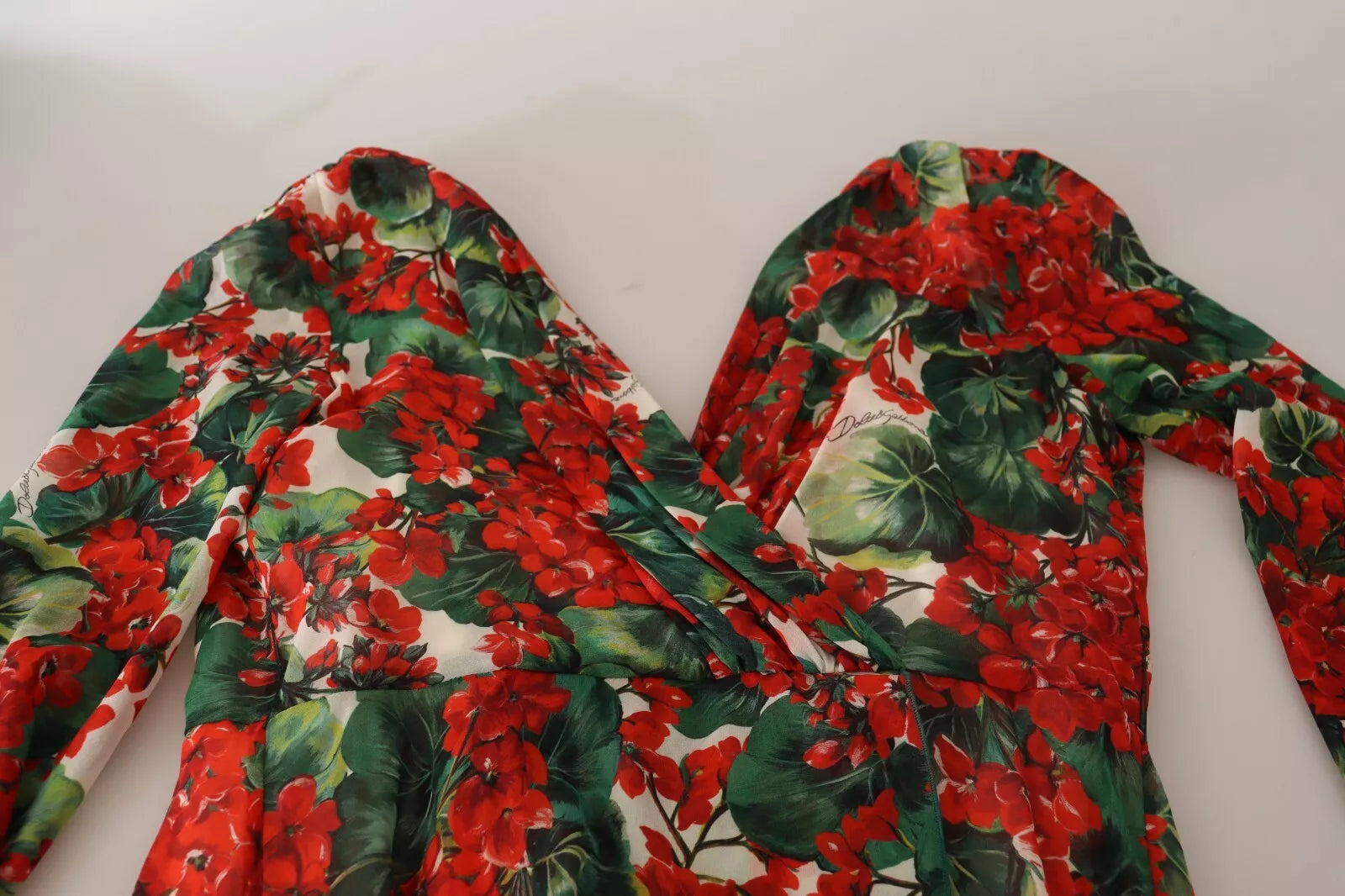 A red and green floral print dress with a V-neckline