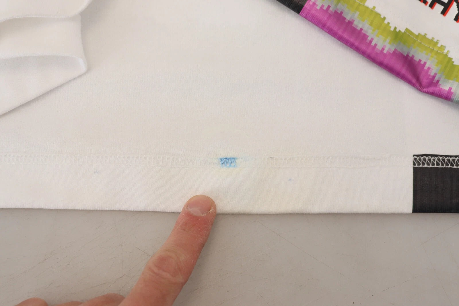 Blue sticker on white fabric
