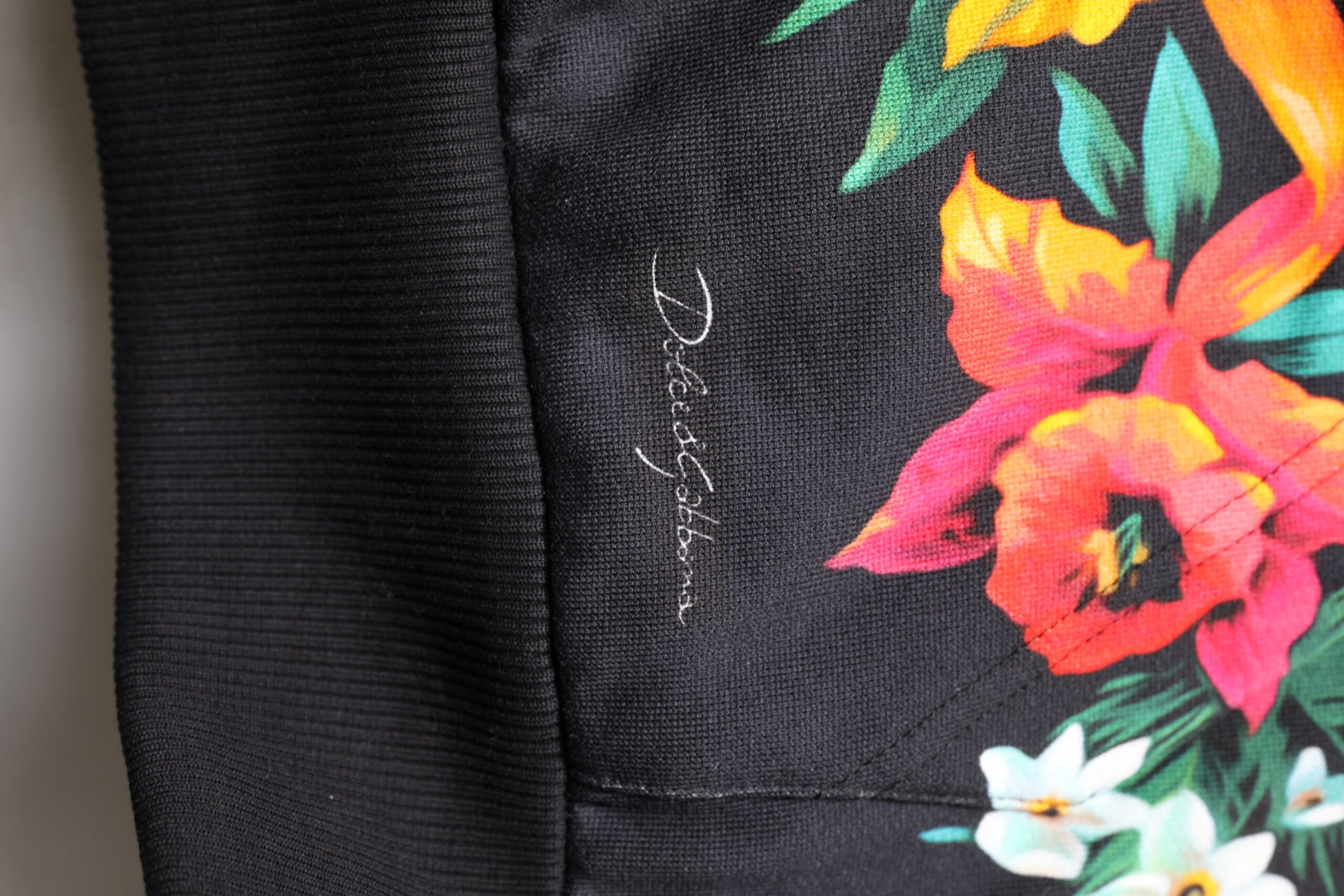 Black fabric with colorful floral pattern on front