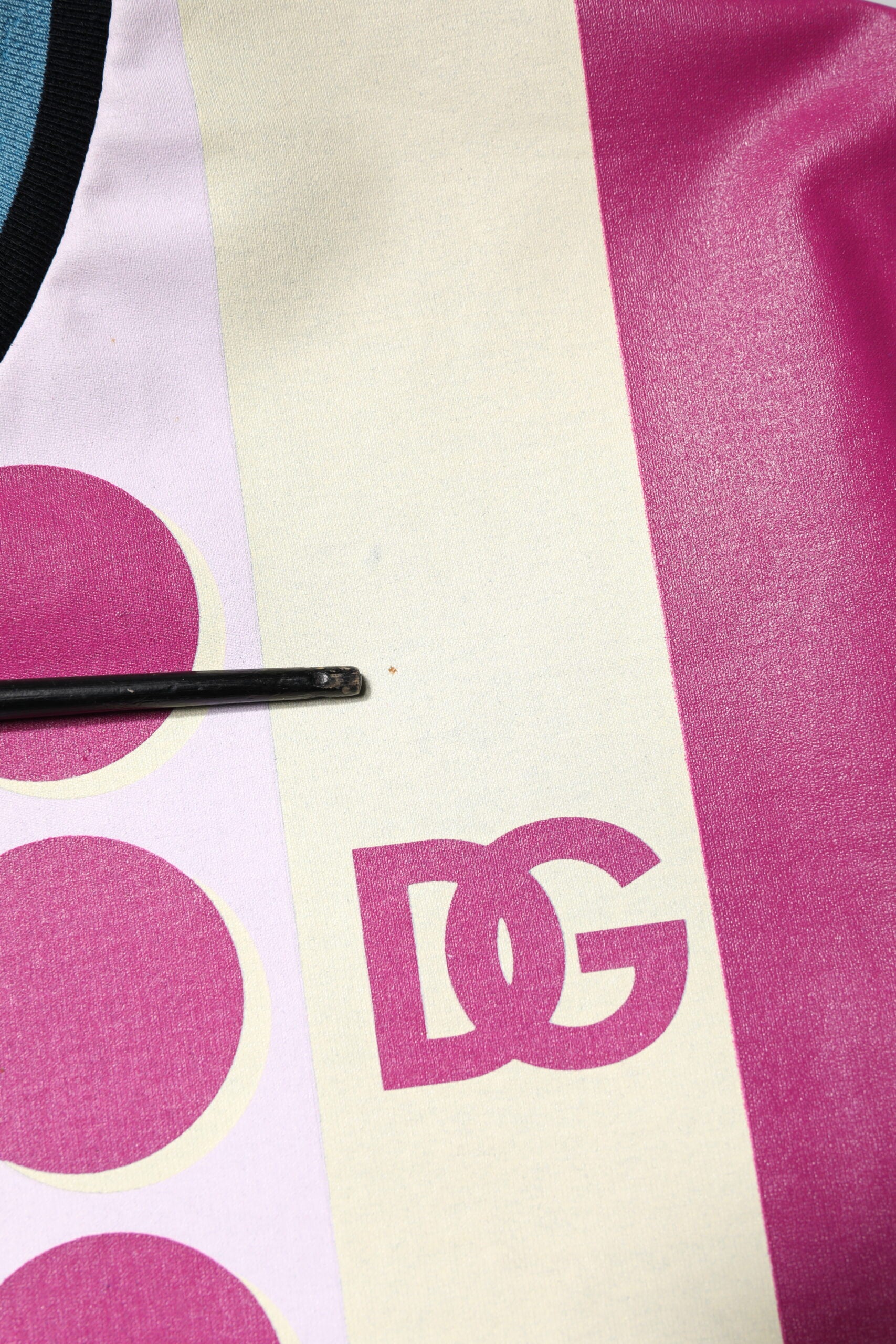 Pink and white polo shirt with pink logo on front