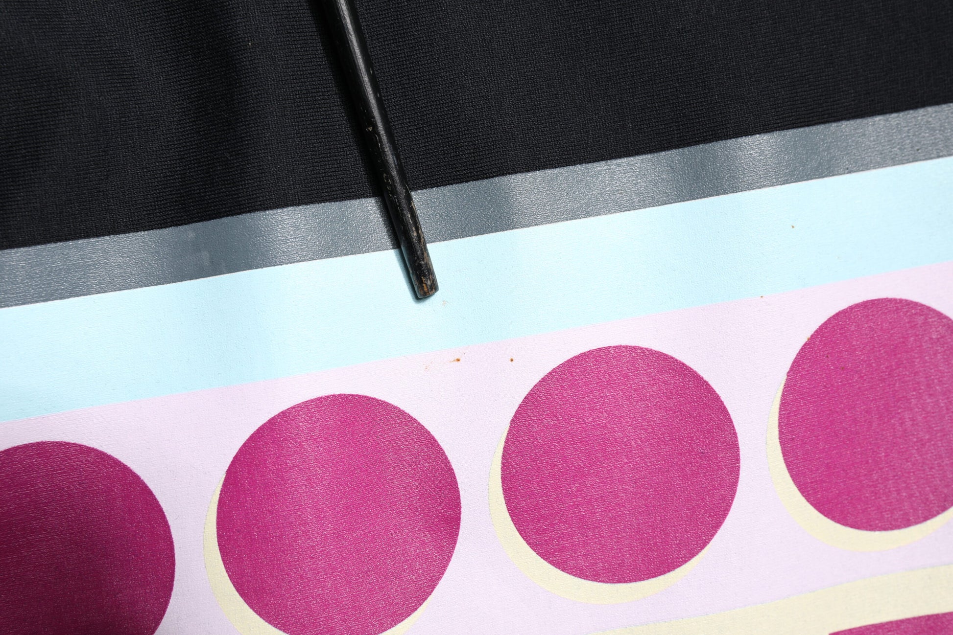 Black jacket with pink circles on sleeve
