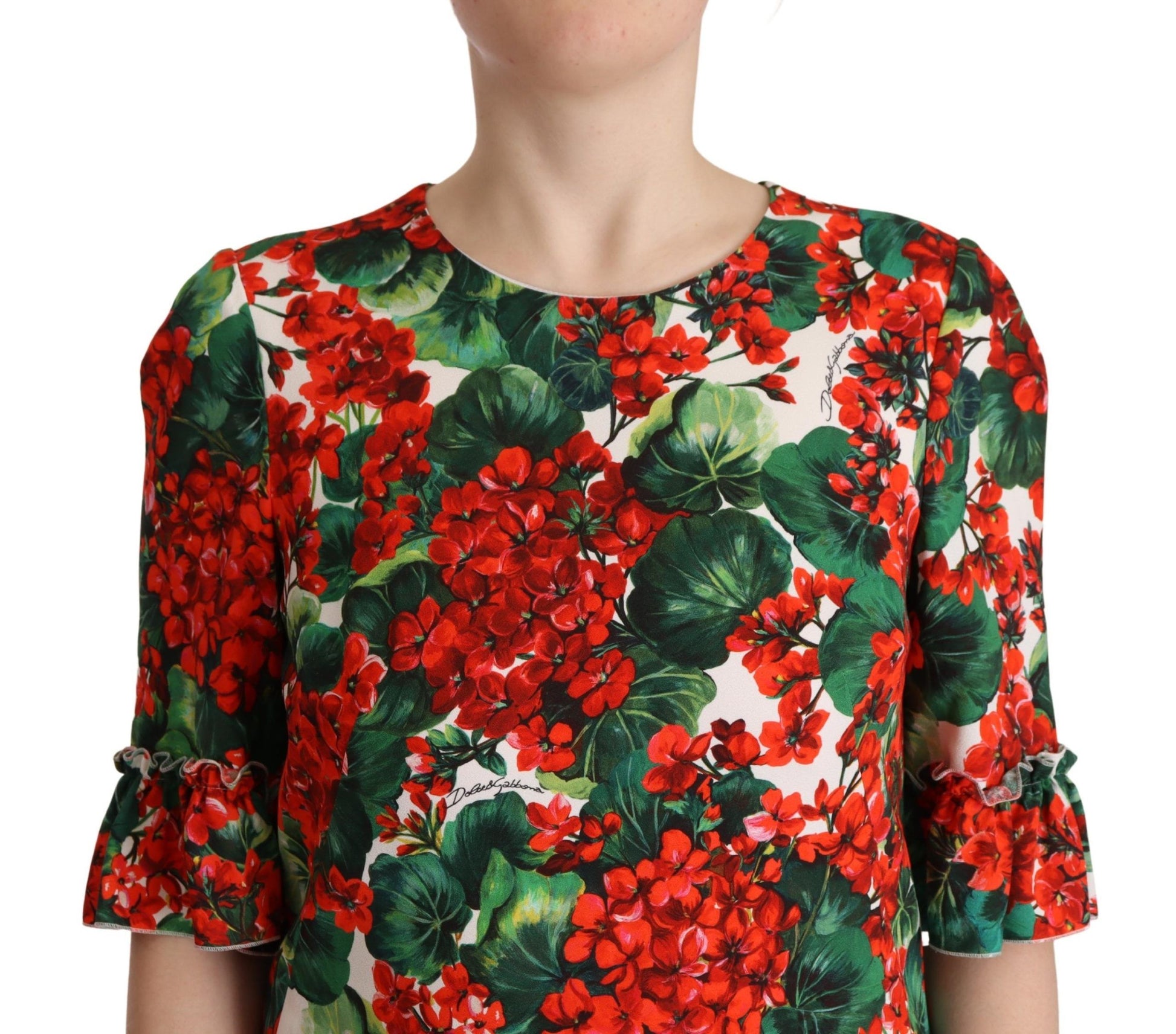 A red floral shift dress with green leaves on a sleeveless garment