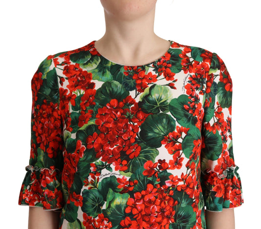 A red floral shift dress with green leaves on a sleeveless garment