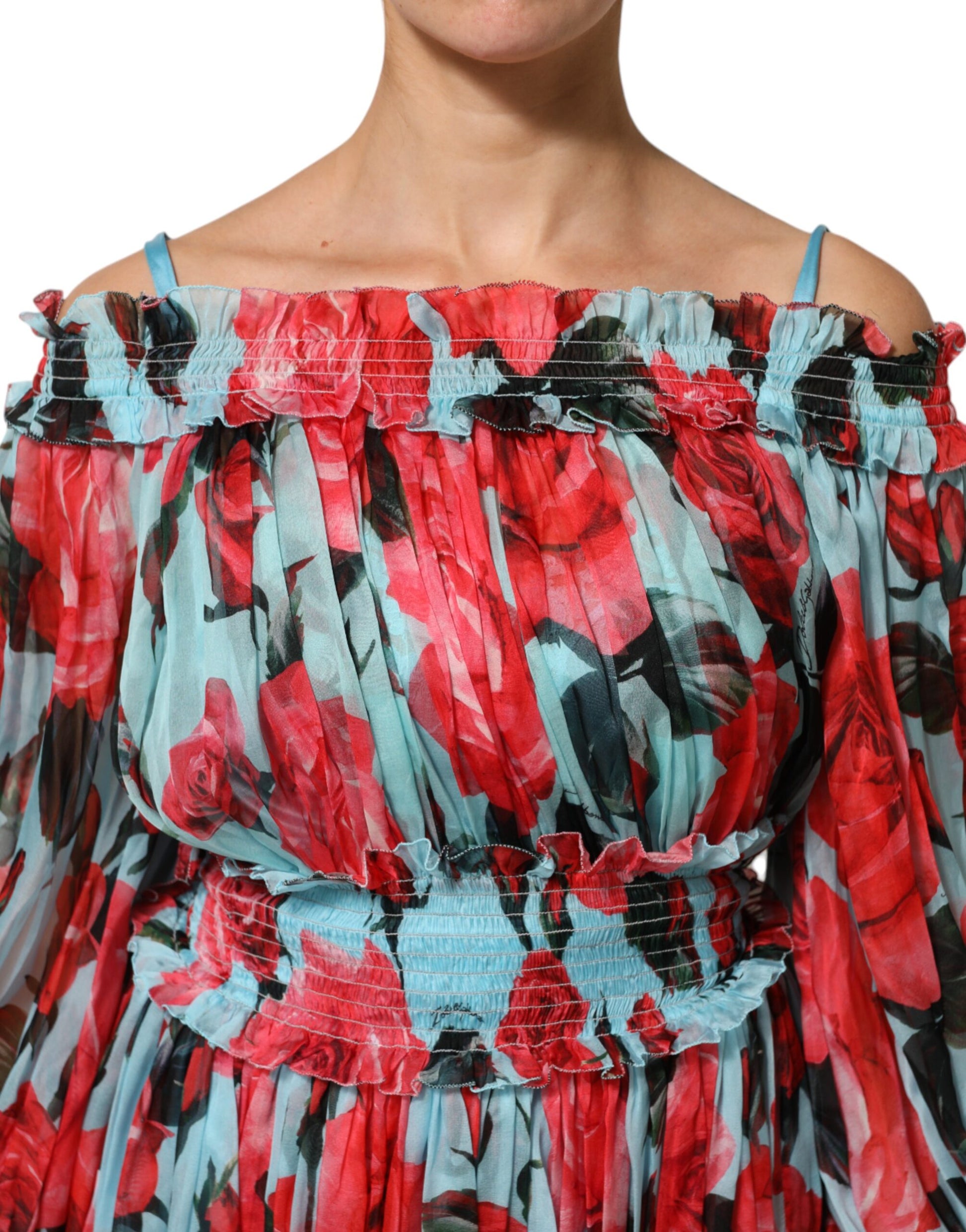 A woman wearing a multicolored floral chiffon dress with ruffled sleeves