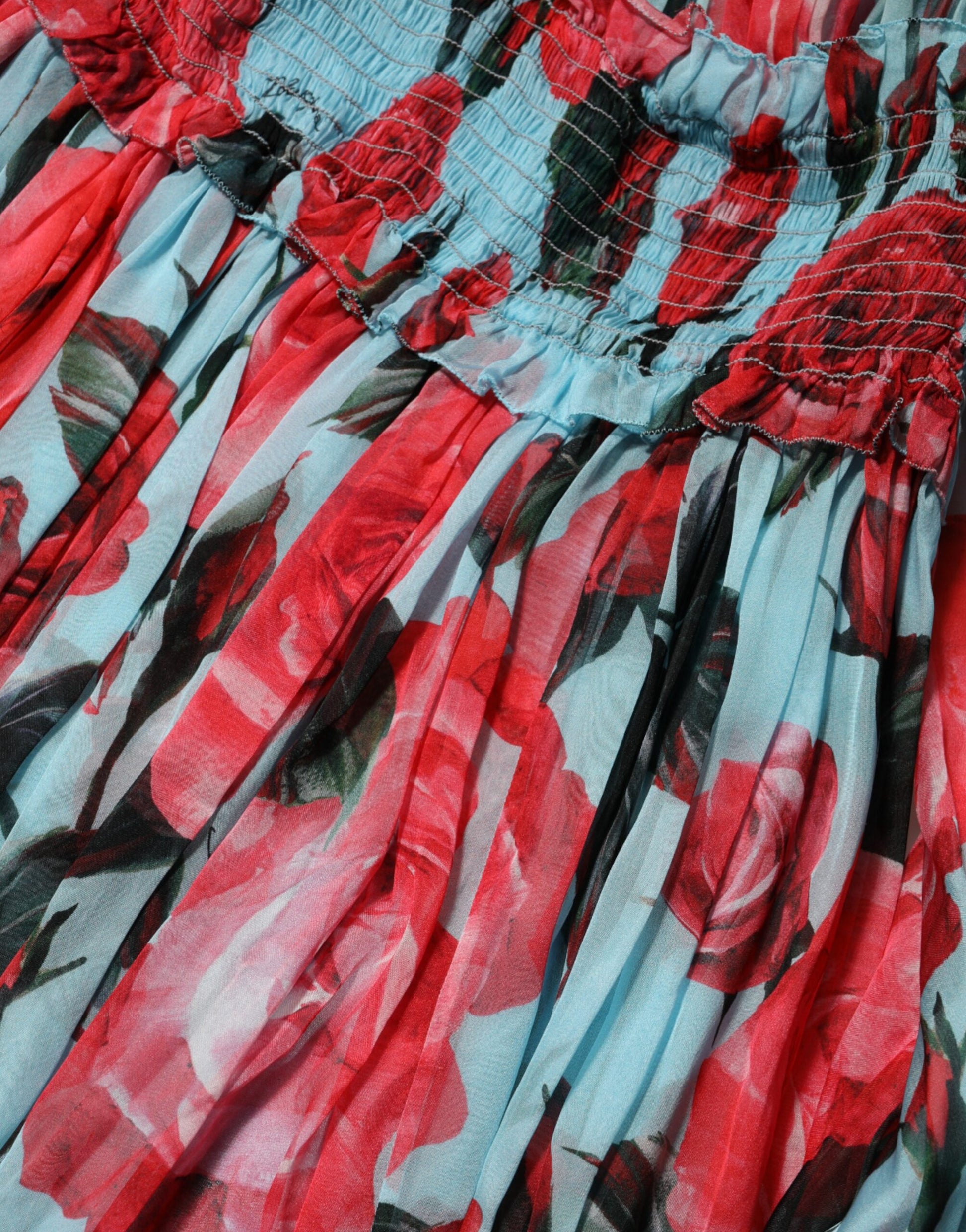 A colorful floral dress with a chiffon skirt and ruffled sleeves