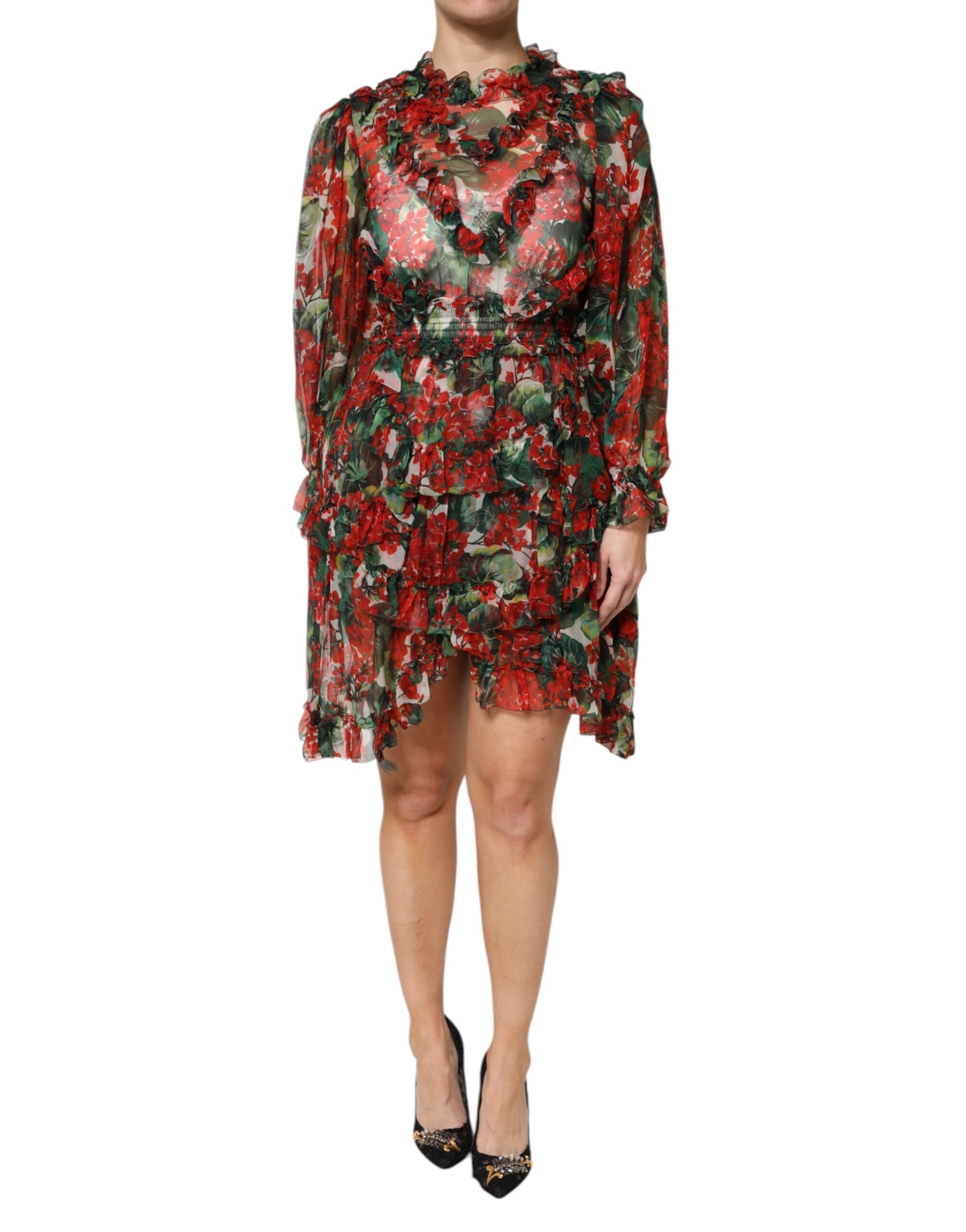 A woman wearing a long sleeve floral dress with ruffles and a high neckline