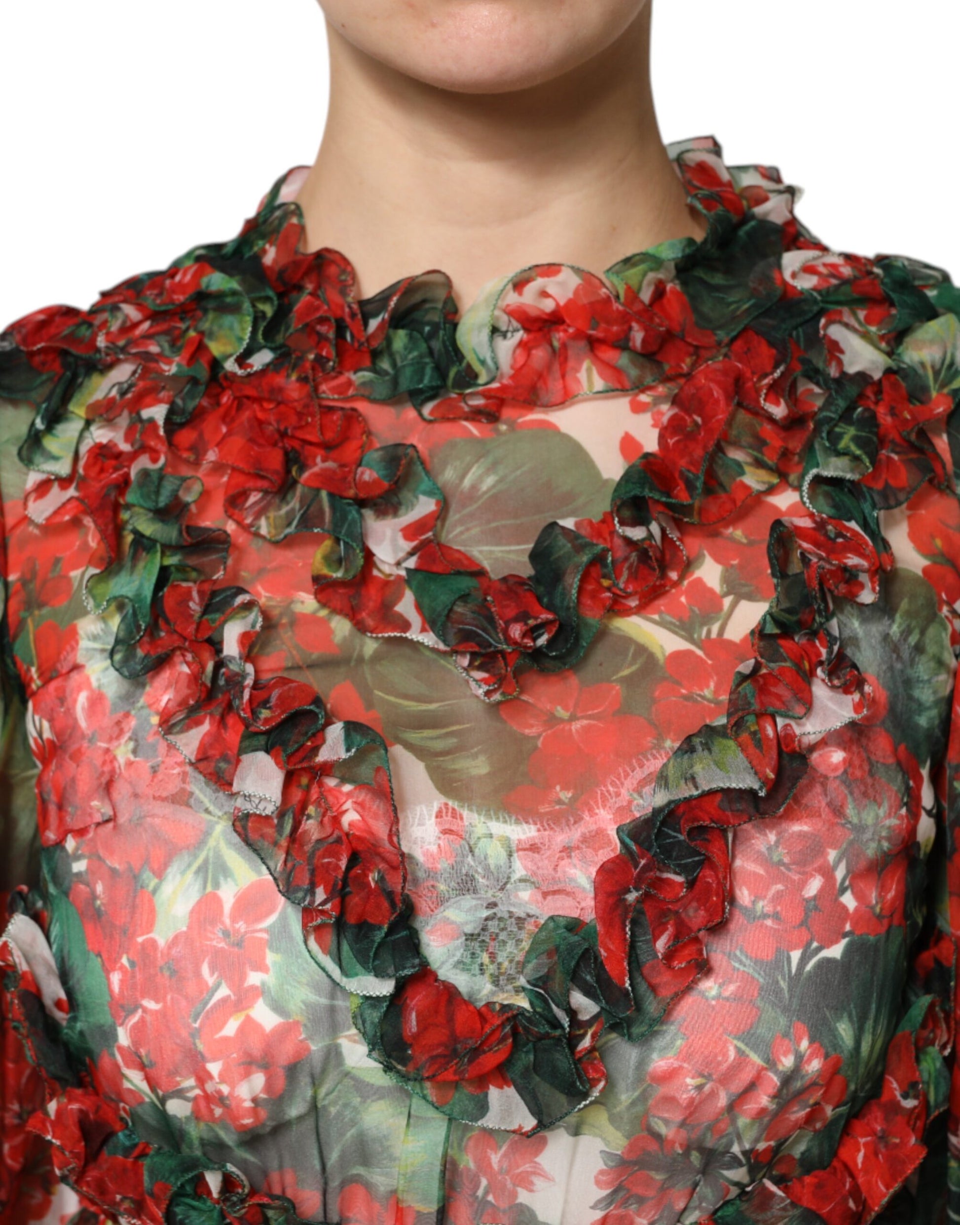 A woman wearing a multicolored ruffle floral dress with long sleeves