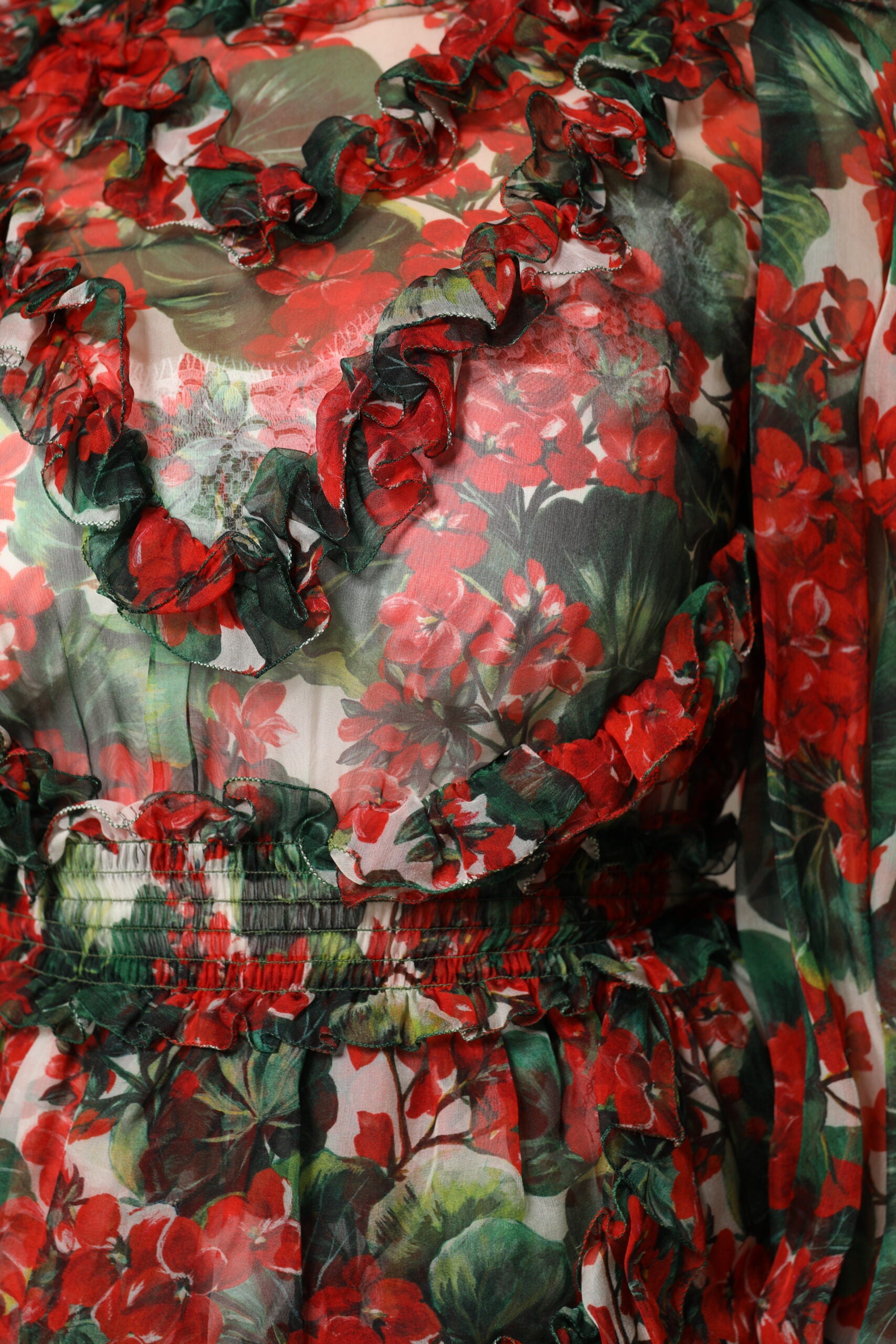 A colorful floral dress with ruffles and long sleeves