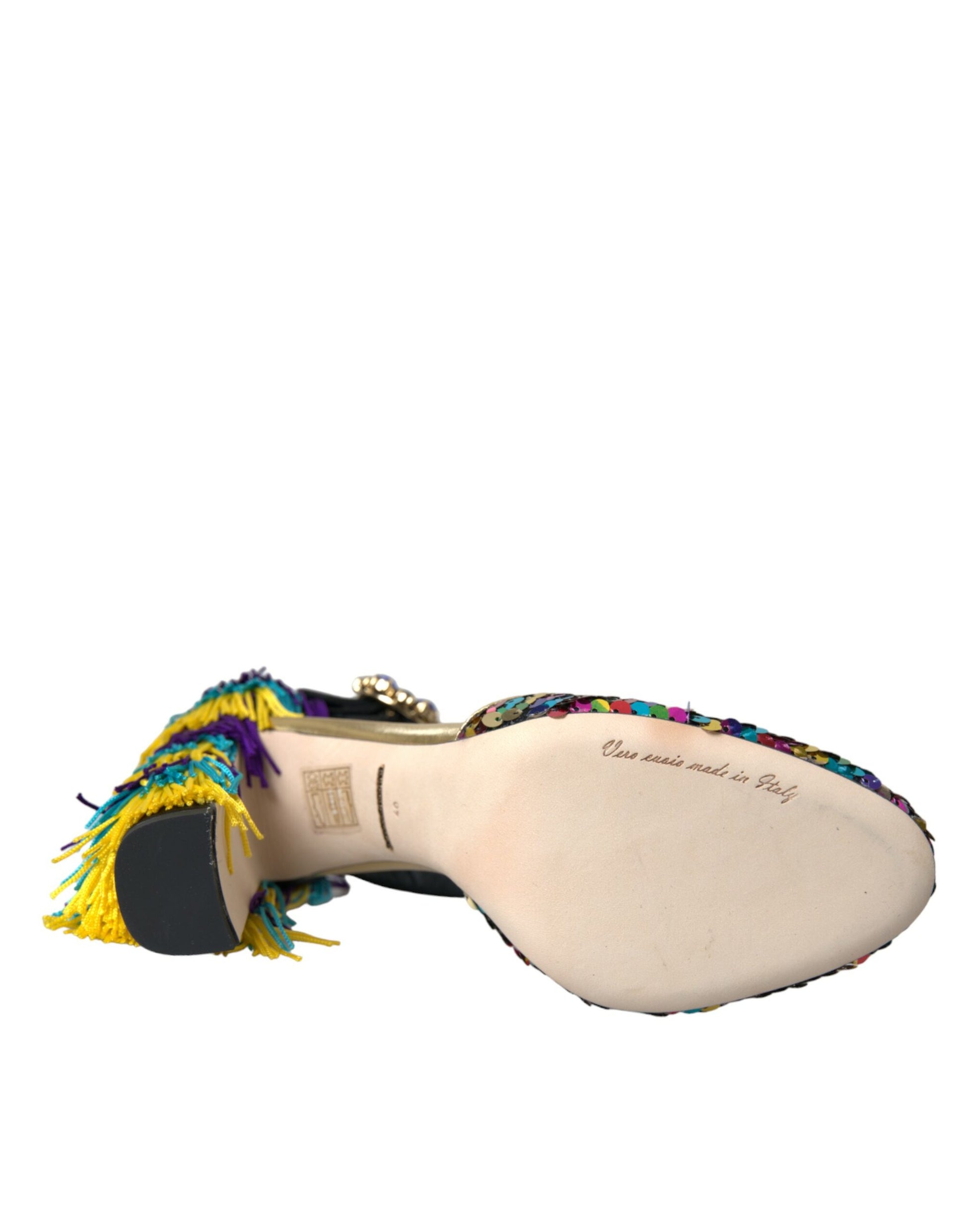 Decorative shoe with colorful fringe and embroidery on top of a wooden block
