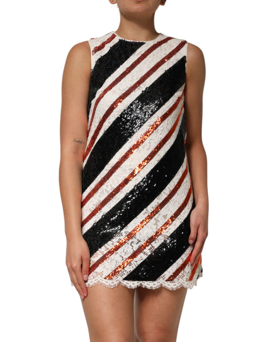 A woman wearing a black, white, red and gold sequin embellished shift dress