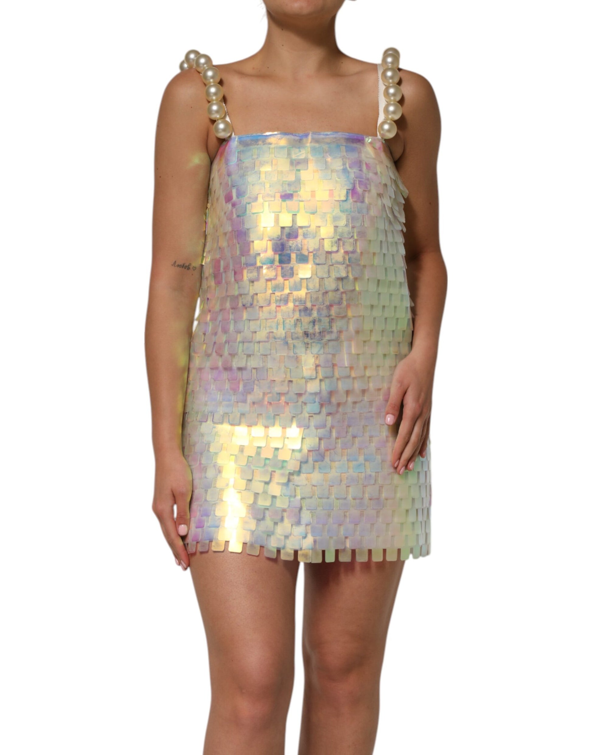 A woman wearing a holographic sequin mini dress by Dolce & Gabbana