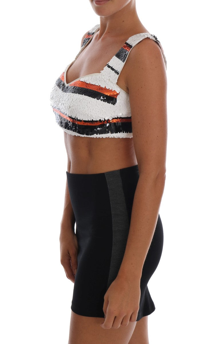Woman wearing black skirt and white top with orange and black design