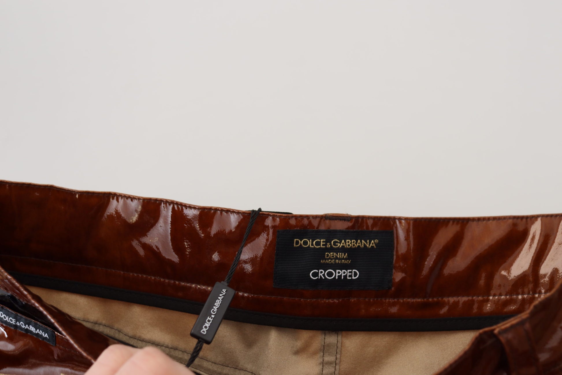 Brown jacket on hanger with brand tag