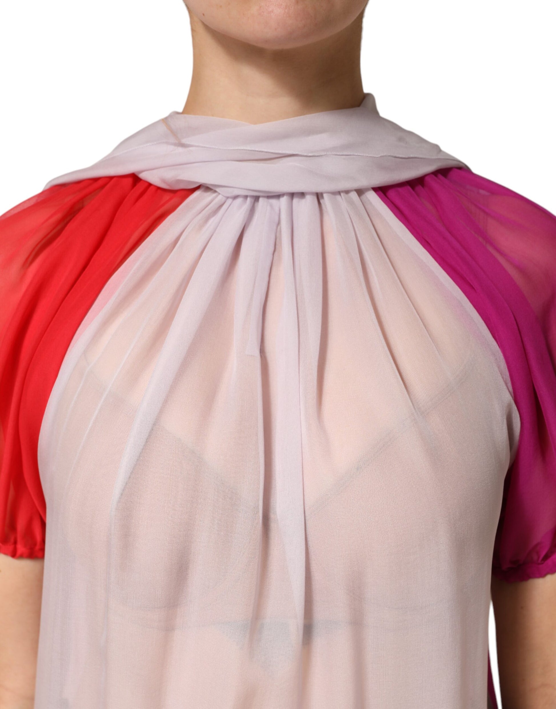 Woman wearing a red and pink scarf around her neck