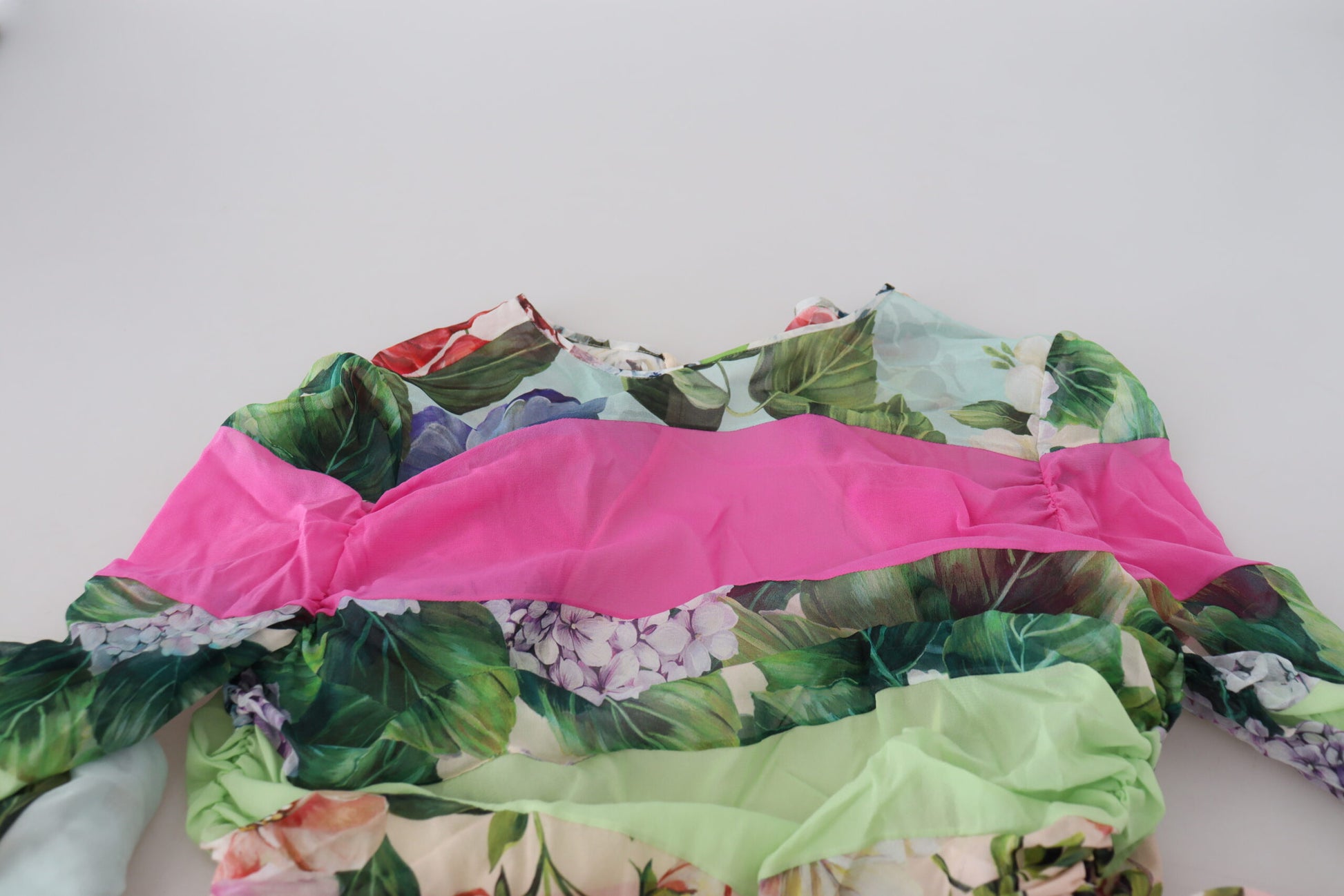 A colorful floral dress with a pink and green border