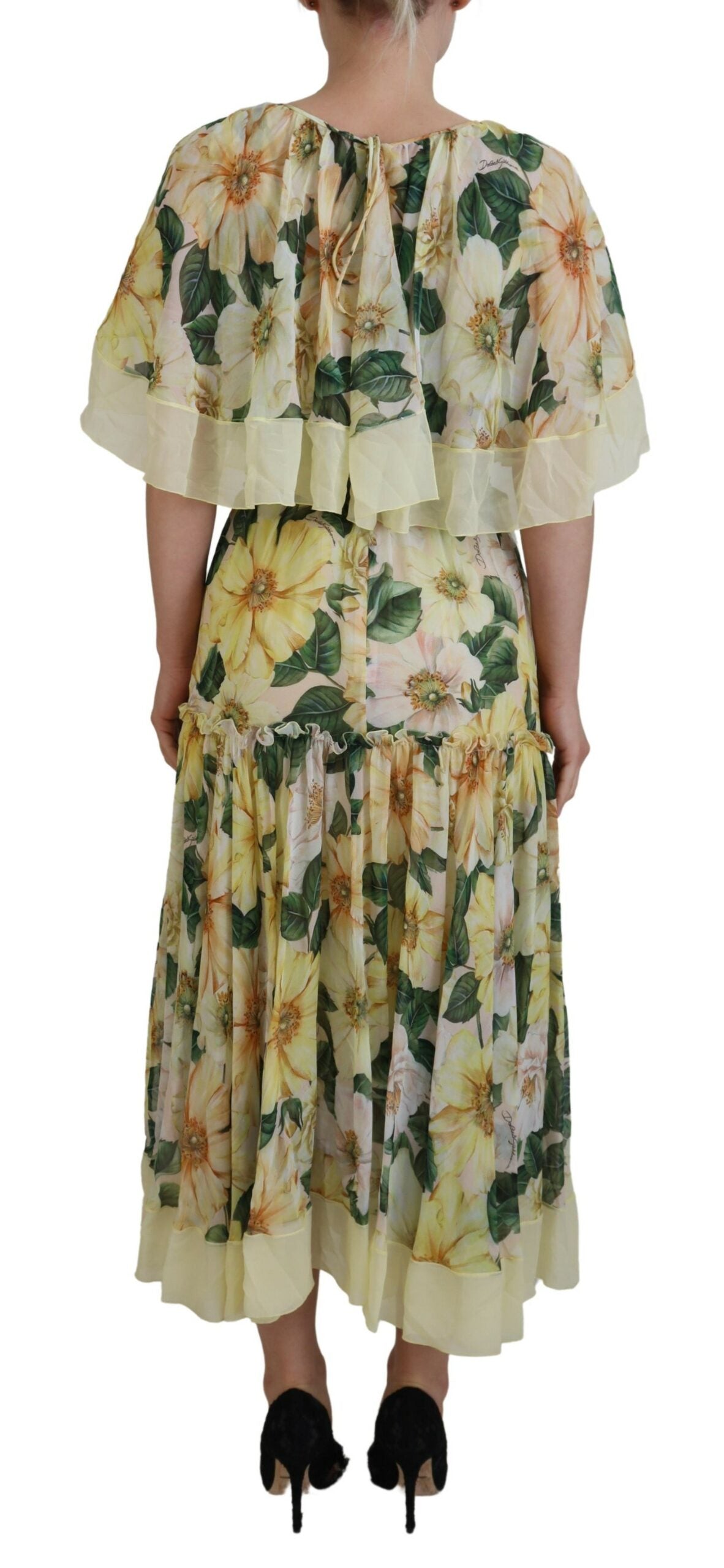 A long, flowing maxi dress with a floral print in shades of yellow and green