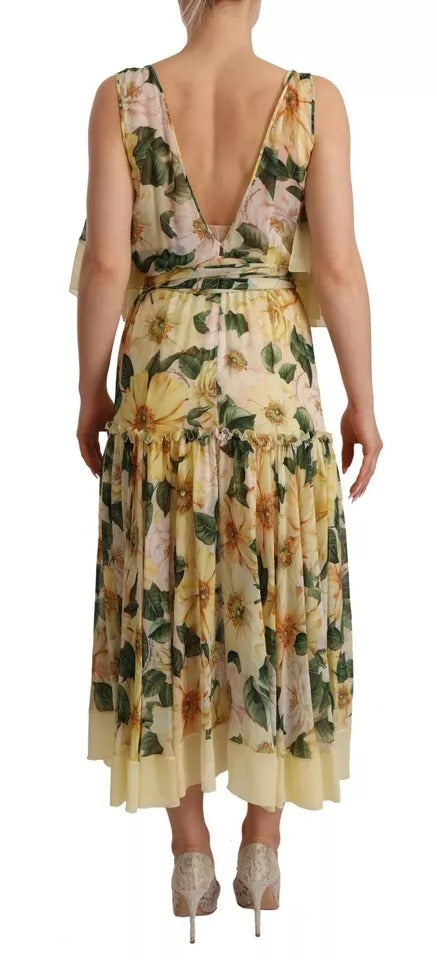 A long, flowing maxi dress with a floral print in shades of yellow and green