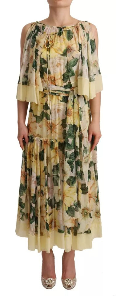 A long, flowing maxi dress with a floral print in shades of yellow and green