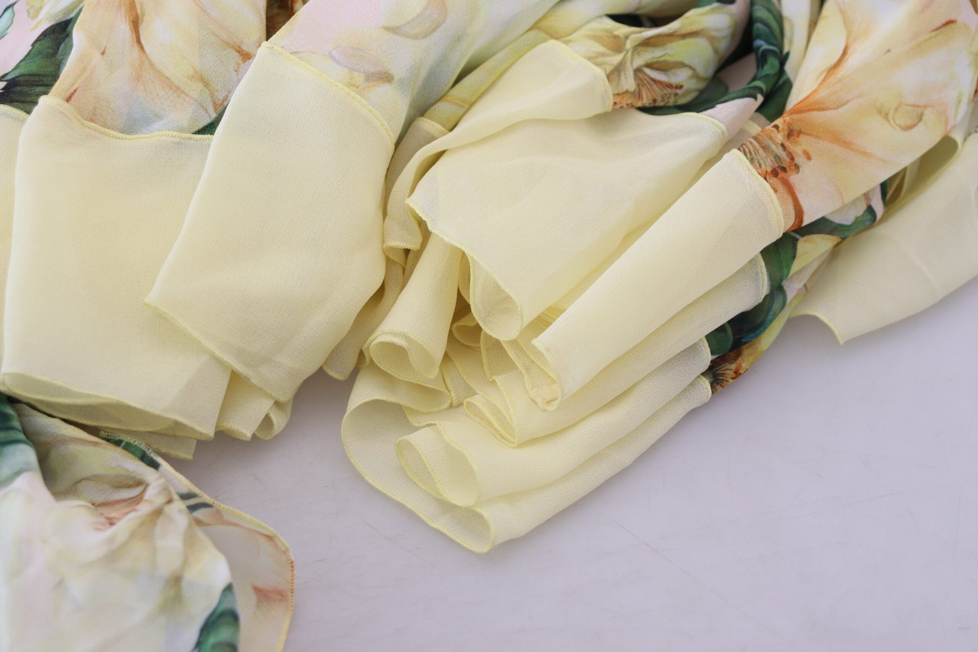 Yellow silk scarf with floral print, part of a long maxi dress