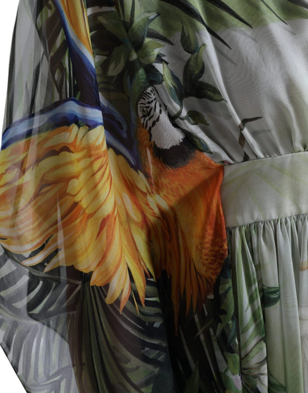 A colorful, silky maxi dress with a jungle print featuring birds and foliage
